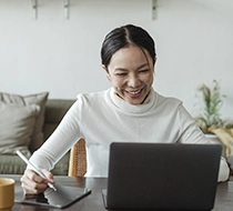 woman working on the laptop and smiling