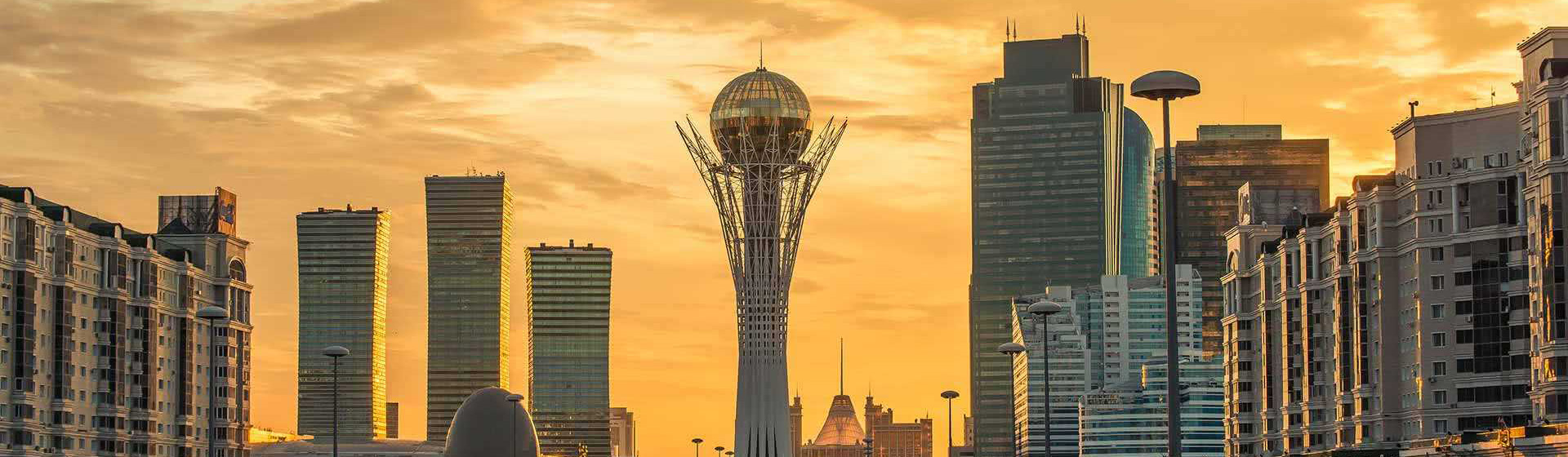 sunset draped skyline with tower containing globe on top