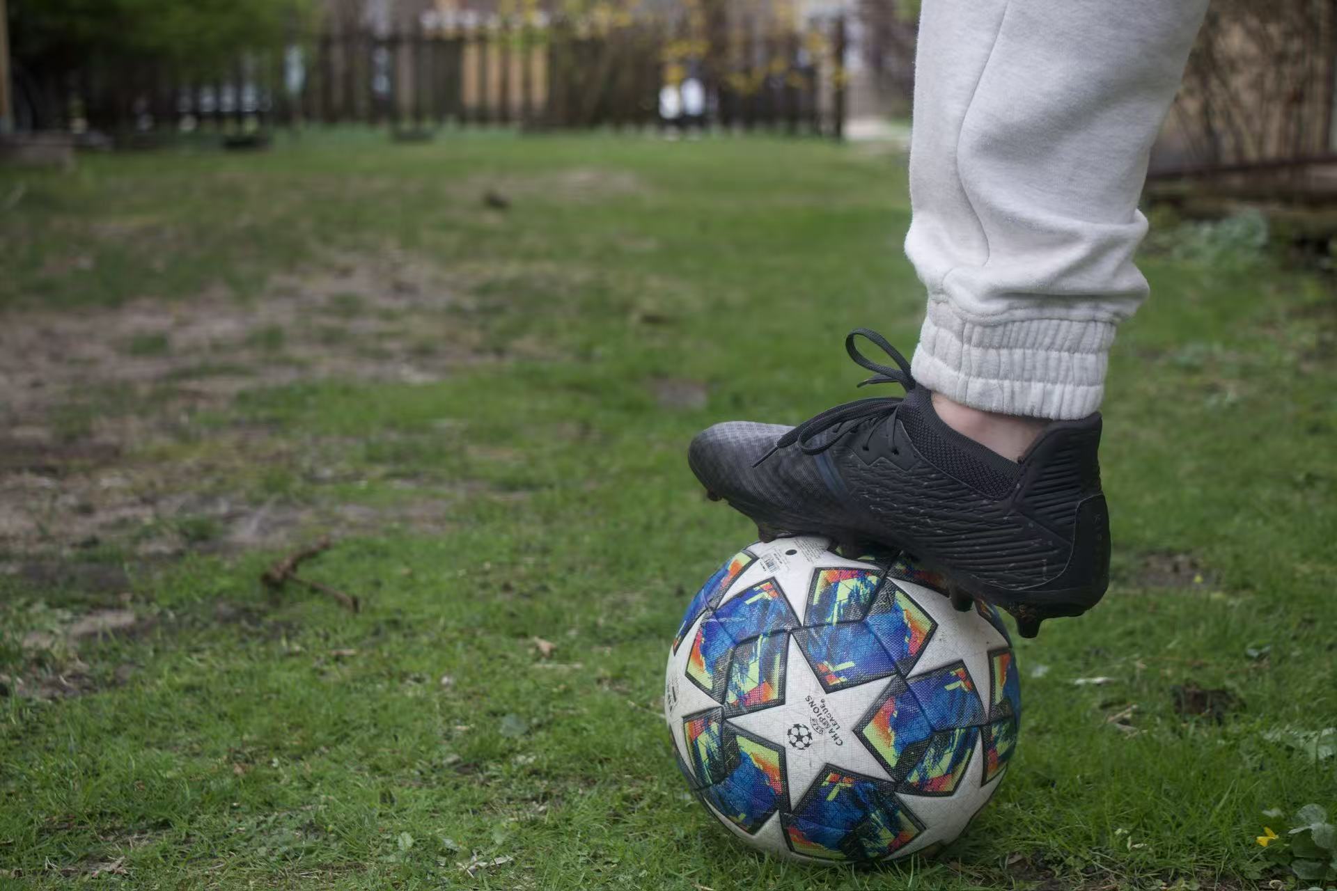 An image of a cleated foot on a soccer ball.