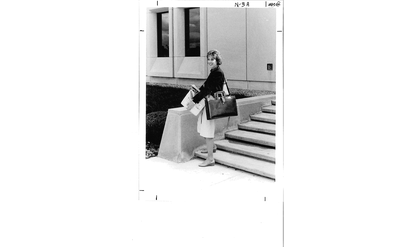 Paula Olszewski-Kubilius on campus holding book.