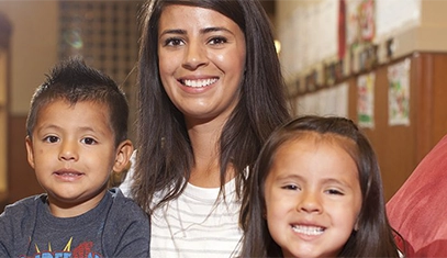 woman and two kids smiling