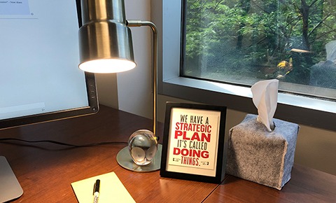 A desk with a lamp and a picture frame