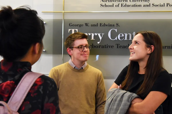 Students chat in Northwestern’s School of Education and Social Policy after master’s project presentations.