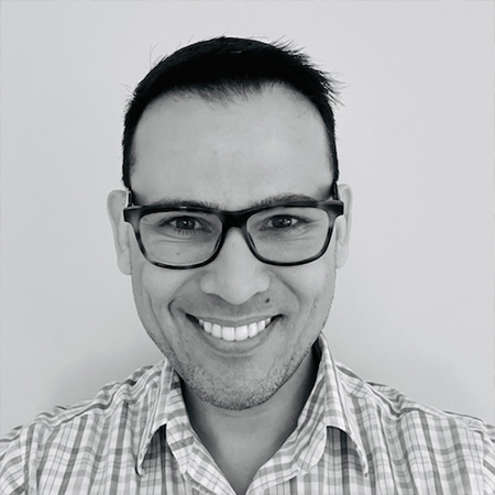 A black and white image of Joao Goebel smiling