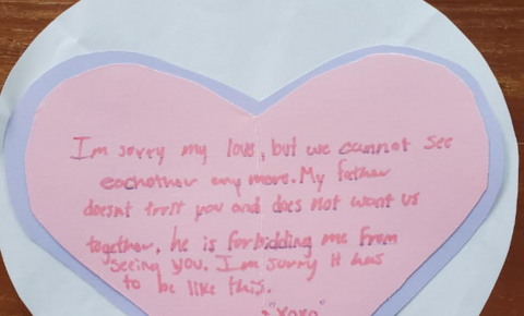 An image of a student's valentine, inspired by Hamlet and Ophelia's relationship. It is a purple and pink heart with handwritten text that says: "I'm sorry my love, but we cannot see each other anymore. My father doesn't trust you and doesn't want us together, he is forbidding me from seeing you. I'm sorry it has to be like this. XOXO