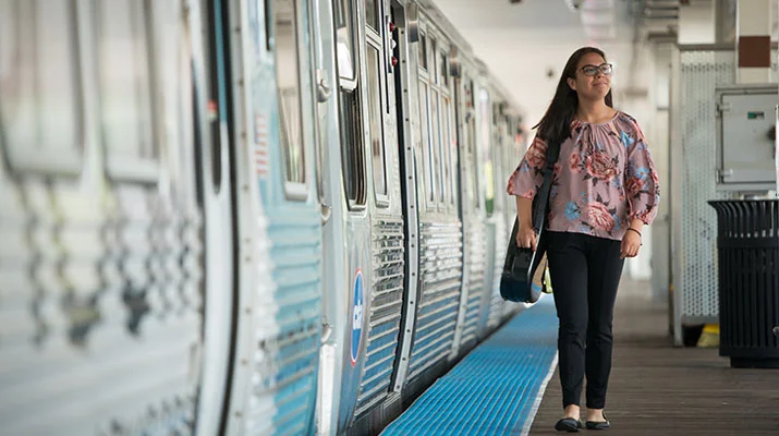 Student walking in Chicago by train