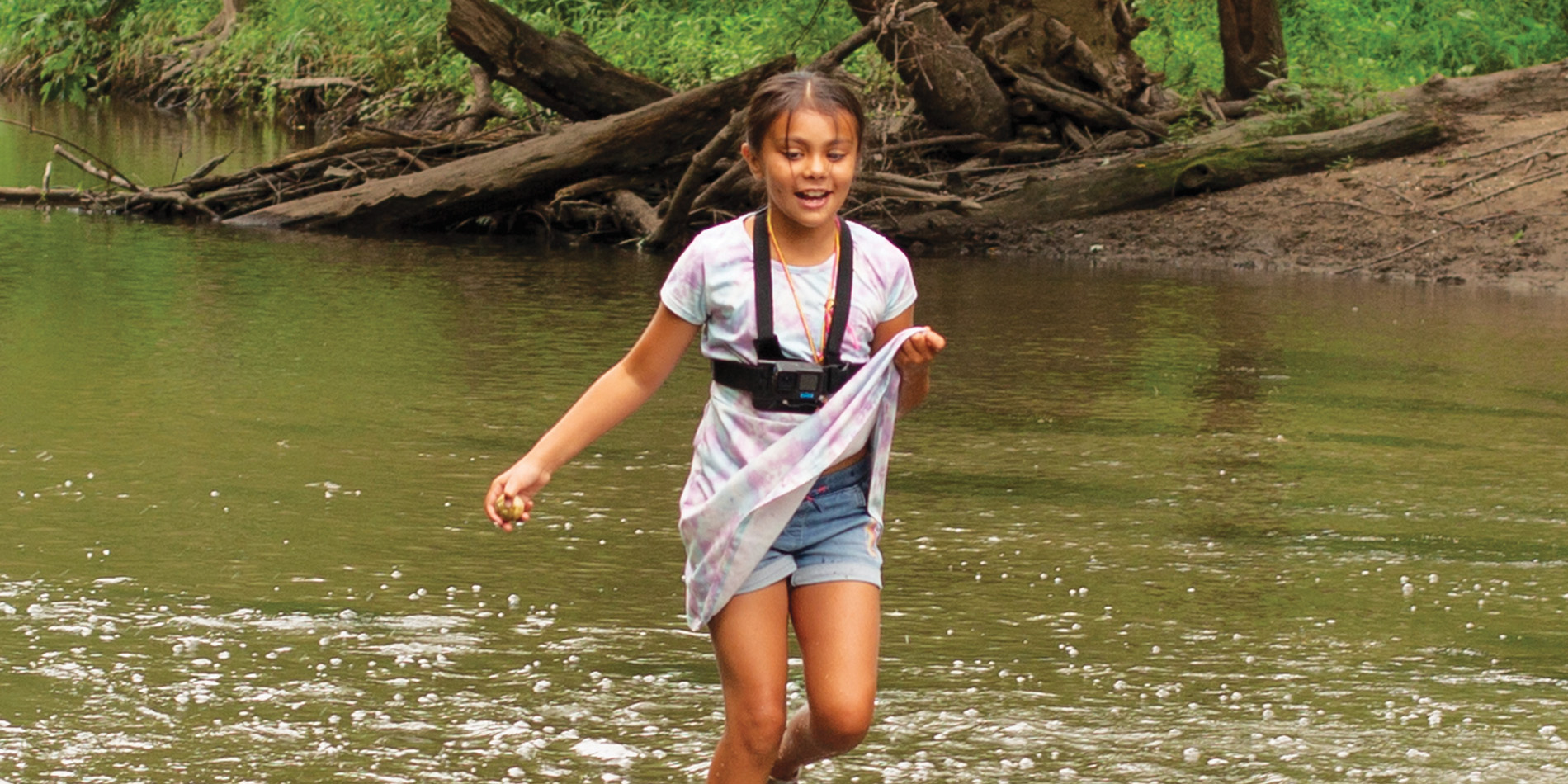 Girl running thorugh a stream