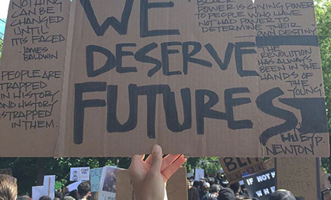 We Deserve Futures sign at protest