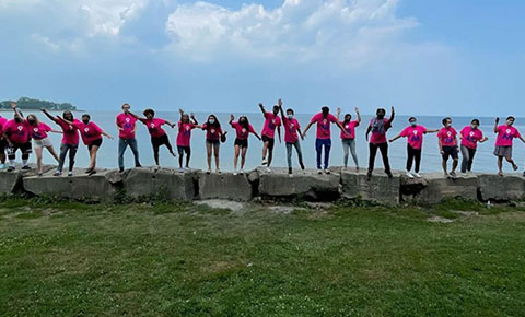 MAPSCorps members standing on rocks at the lake